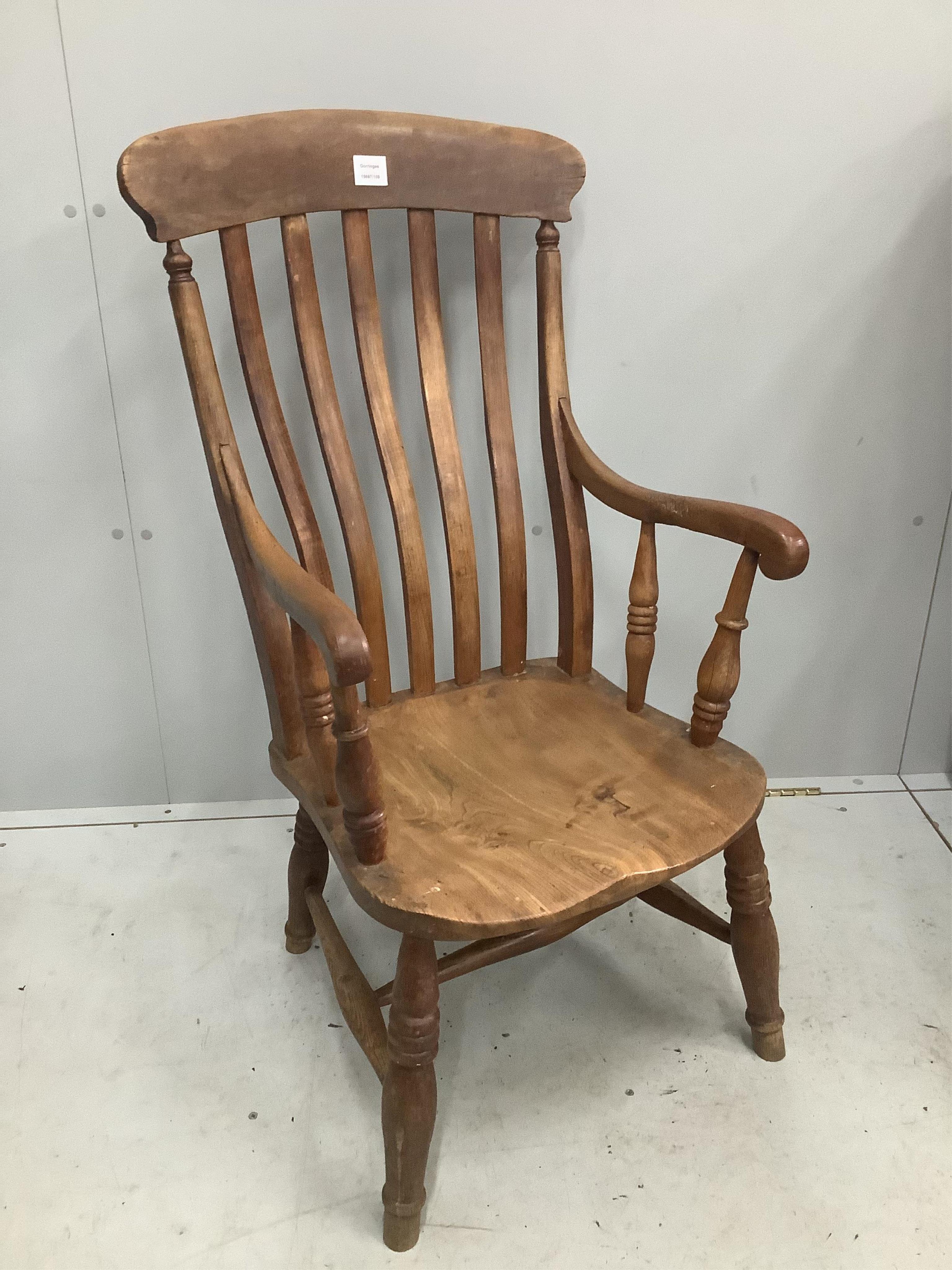 A Victorian elm and beech Windsor lathe back elbow chair, width 53cm, depth 44cm, height 104cm. Condition - fair